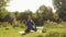 Woman practicing yoga at sunrise in park. Young spiritual girl doing stretching exercises on nature outdoors. Concept of fitness,