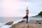 The woman practicing yoga sunset on the beach.