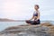 The woman practicing yoga sunset on the beach.