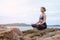 The woman practicing yoga sunset on the beach.