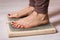 A woman practicing yoga therapy stands on a board with nails. Concept on the topic of massage