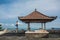 Woman practicing yoga in traditional balinesse gazebo