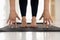 Woman practicing yoga, uttanasana pose, hands and feet close up