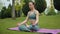 Woman practises yoga in forest. Girl meditates in nature outdoors. Fitness
