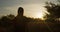 Woman practises yoga at sunrise. Young spiritual girl walkin in nature outdoors, slow motion