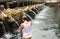 Woman in prayer in holy water at Pura Tirta Empul, hindu temple