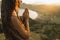 Woman praying alone at sunrise. Nature background. Spiritual emotional concept