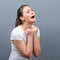 Woman praying about something or begging for mercy against gray background