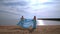 Woman pregnant on beach sea. Pregnant woman in blue dress flying on wind