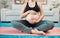 Woman, pregnant and holding stomach, yoga and pilates exercise on the floor, living room and home. Mother, pregnancy or