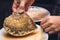 Woman is preparation a big oyster mushrooms for a gourmet dining meal