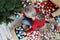 Woman prepare christmas tree with cardboard boxes full of christmas balls and decorations, preparation concept top view background