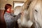 Woman prepare horse for riding