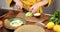 Woman prepares breakfast with eggs and avocado