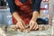 A woman prepares Christmas cookies at home in the kitchen decorated for Christmas. Homemade cooking. Women& x27;s hands