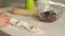 A woman prepares dumplings with blueberries. Covers the berries with dough. Close-up shot