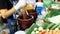 A woman prepares green papaya salad