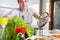 Woman prepares a healthy meal in modern kitchen.