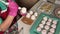 A woman prepares marshmallow cones. Ready-made sweets are laid out on trays. Close-up shot