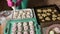 Woman prepares marshmallow sandwiches. Ready-made sweets are laid out on trays. Close-up shot