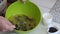 A woman prepares muffins with chocolate and raisins. mixes butter, sugar and raisins. Nearby chocolate. Close-up shot