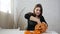 A woman prepares a pumpkin for Khlloin, takes out seeds and pulp