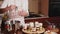 A woman prepares sweet desserts on her kitchen, a lady smears cream in a glass