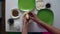 A woman prepares sweets from condensed milk, coconut shavings and almonds. She rolls a ball in her hands, puts almonds inside, and