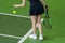 A woman prepares to serve a tennis ball during a match