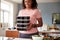 Woman Preparing Batch Of Healthy Meals At Home In Kitchen