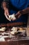 A woman is preparing buns from puff pastry oaking apple envelopes puff pastry cakesn a table in a bakery