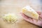 Woman preparing cheese for cook using cheese grater in the kitchen