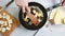 Woman preparing cheese on a frying pan.