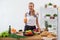 Woman preparing dinner in a kitchen, drinking juice concept cooking, culinary, healthy lifestyle.