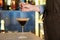 Woman preparing Espresso Martini on bar counter. Alcohol cocktail