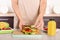 Woman preparing food for her child at table in kitchen, closeup