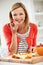 Woman Preparing Fruit Salad In Kitchen