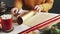 Woman preparing golden paper to wrapping Christmas Presents On Table With Christmas Decoration.