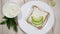 A woman is preparing a healthy breakfast - toast with soy cheese and avocado. Healthy breakfast concept, vegetarian food