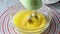 Woman preparing homemade omelette beating eggs with electric mixer