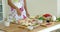 Woman preparing a homemade pizza in the kitchen