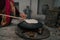 Woman preparing or making borek or bread dough on fire