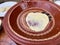 Woman preparing Moroccan flatbread, M'Semen, in traditional ceramic bowl.