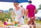 Woman preparing picnic table in summer park