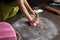 Woman preparing pink fondant for cake decorating, hands detail