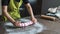 Woman preparing pink fondant for cake decorating, hands detail