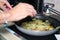 Woman preparing sliced potatoes in a bowl