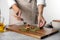 Woman preparing stuffed grape leaves at table, closeup