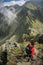 Woman preparing to embark on a dangerous scrambling trail in the mountains