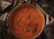 Woman preparing tomato soup at the kitchen